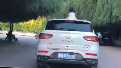 惊险!青海一女童竟端坐在行驶中的轿车车顶!